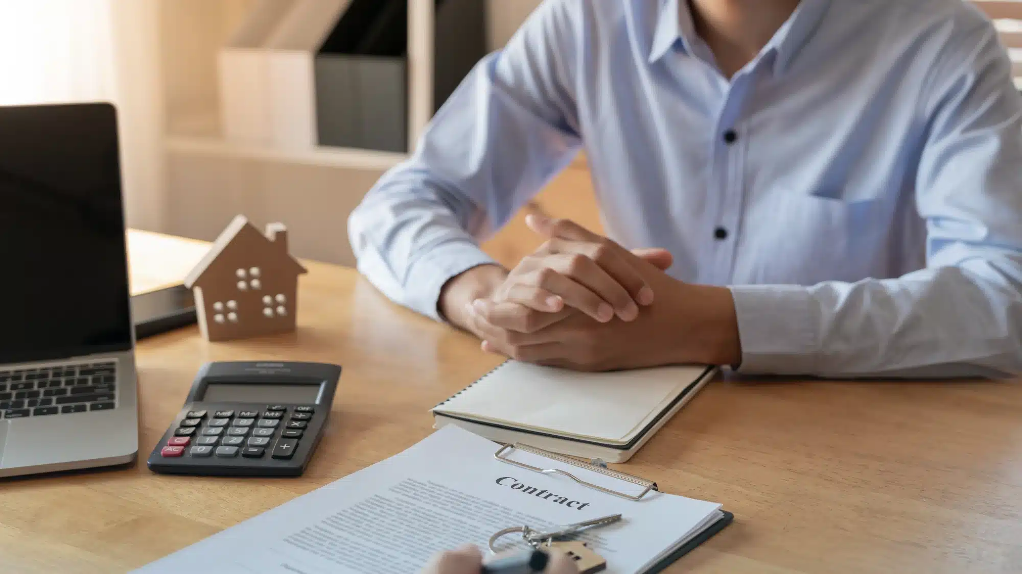 homeowner reviewing documents and calculator to understand home insurance costs and pricing factors in waterford connecticut